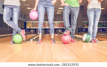 scene with four people and bowling balls. concept about bowling, fun and leisure. floor view
