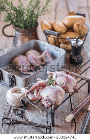 Raw quails ready to be cooked