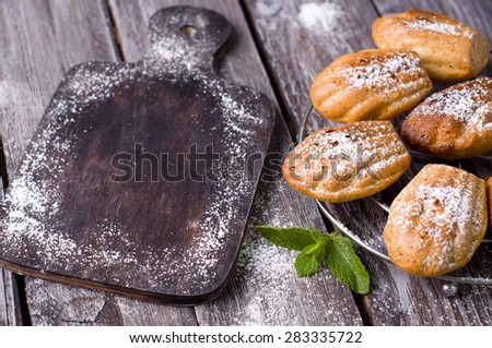 Madeleine cookies with cinnamon and poppy seeds on a dark wood background. tinting. 