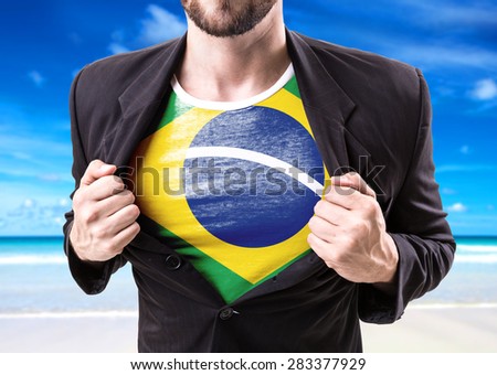 Businessman stretching suit with Brazil Flag on beach background