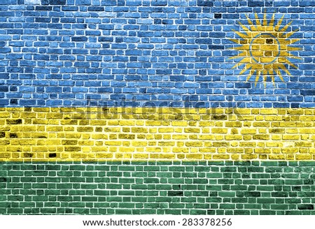 Flag of Rwanda painted on brick wall, background texture