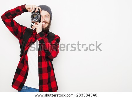 life style, tehnology and people concept: professional photographer. Portrait of confident young man in shirt  holding  camera over white background