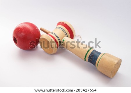 Kendama, a traditional Japanese toy consisting of a sword and a ball connected by a string rolled in heart shape, isolated on white background