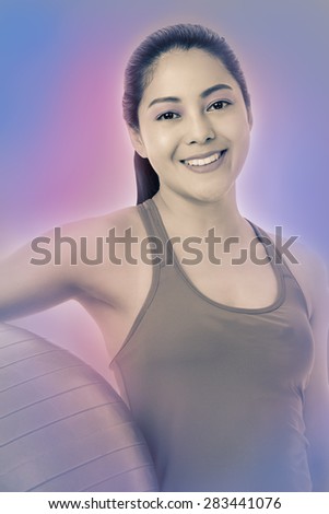 Healthy woman - beautiful asian (thai) girl smiling and holding a fitness ball. Vintage and retro picture style