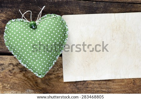 Heart decoration object with card on wooden background