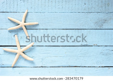Starfish on wooden background. Sea objects on aged wooden table