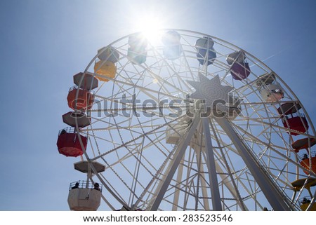 Ferris wheel over blue sky - retro styled photo