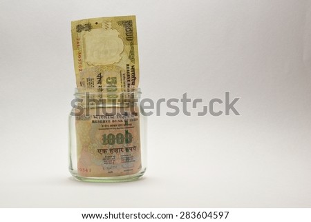 Indian currency notes of rupee 1000 and 500 in glass jar