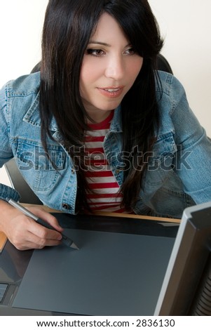 A female working with a graphic tablet.