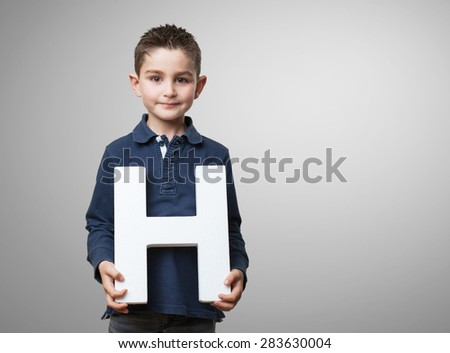 little kid holding the h letter