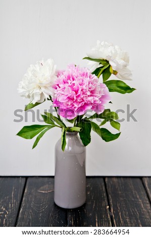 Pink and white peonies in a vase