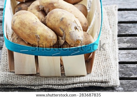 New potatoes on a rustic wooden table.Selective focus.