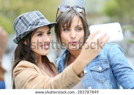 Girlfriends taking selfie picture with smartphone