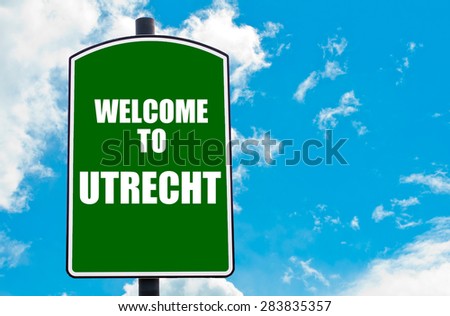 Green road sign with greeting message Welcome to UTRECHT isolated over clear blue sky background with available copy space. Travel destination concept  image