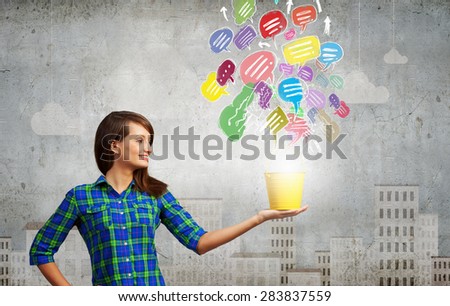 Young woman in casual with yellow bucket in hands 