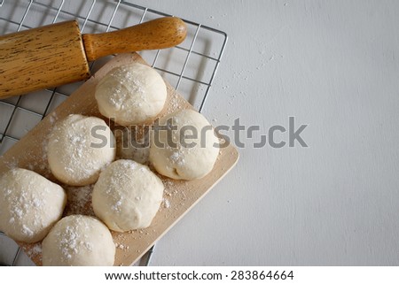 Yeast dough of homemade bread or pizza on wooden board