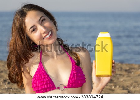Attractive woman showing sun cream