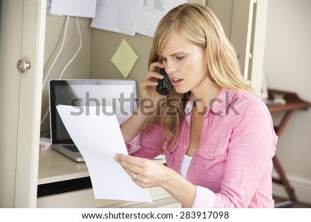 Woman Working In Home Office On Phone Royalty-Free Stock Photo #283917098