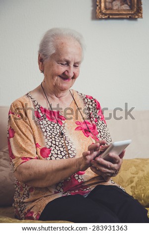 Senior woman using mobile phone with her hands