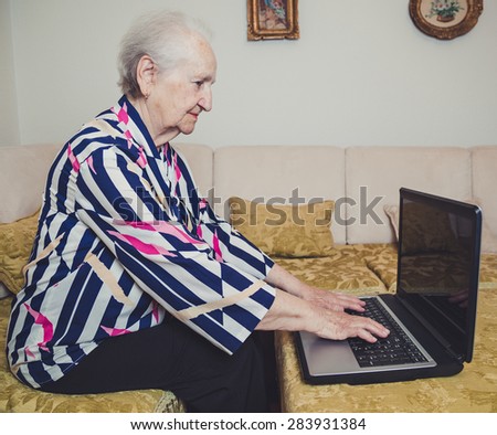 Senior woman typing on laptop