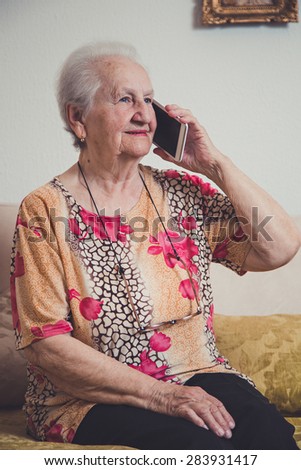 Senior woman talking on a mobile phone and smiling