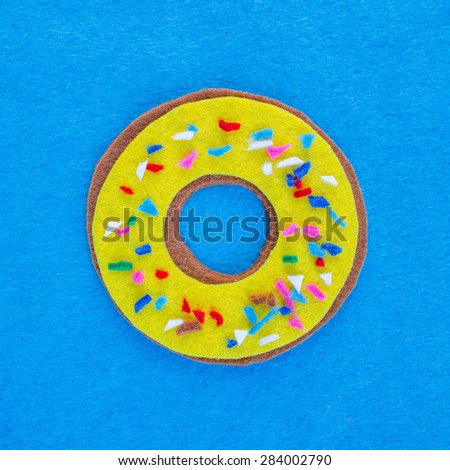 Donut with sprinkles isolated on blue  background