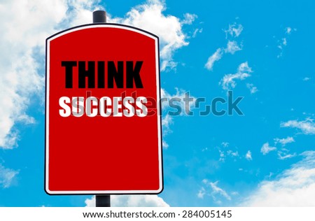 Think Success motivational quote written on red road sign isolated over clear blue sky background. Concept  image with available copy space