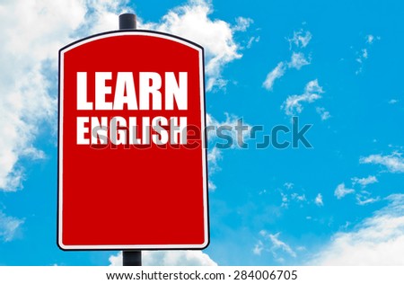 Learn English  motivational quote written on red road sign isolated over clear blue sky background. Concept  image with available copy space