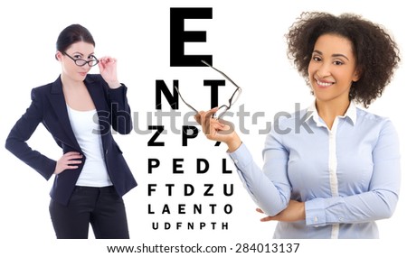 two business women in glasses and eye test chart isolated on white background