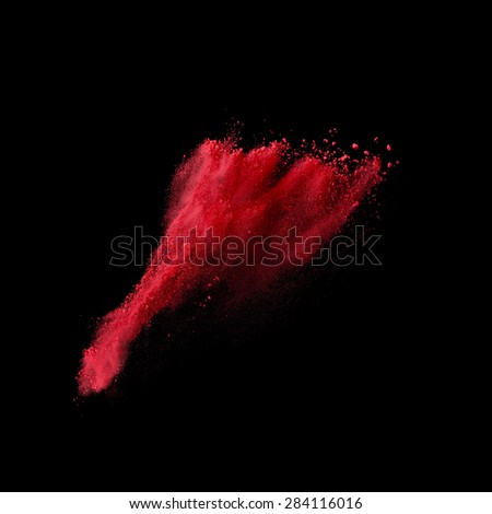 Red powder explosion isolated on black background