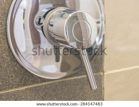 close up shower faucet in bathroom
