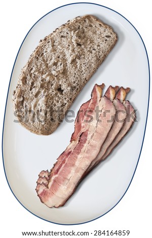 Bacon Rashers And Slice Of Brown Bread Offered On Oblong Porcelain Platter Isolated on White Background