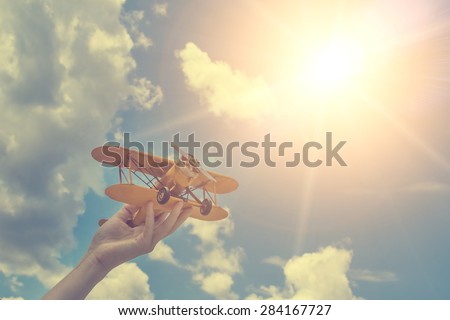 Toy airplane in hand - a symbol of travel and dreams Royalty-Free Stock Photo #284167727
