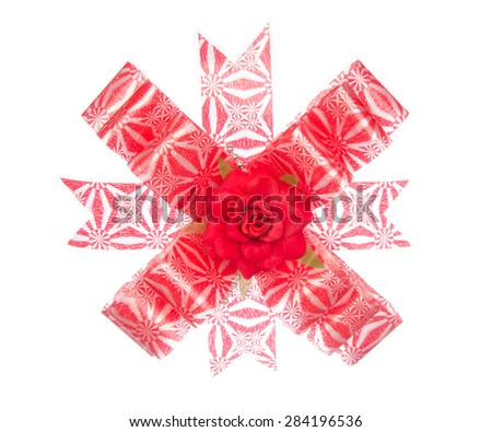 Red ribbon bow with red flower isolated on white background