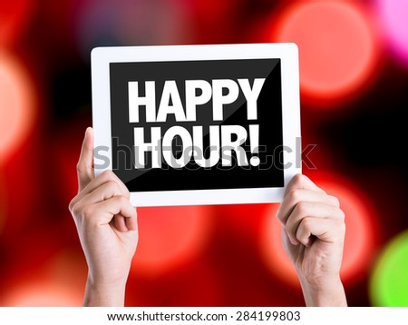 Tablet pc with text Happy Hour with bokeh background