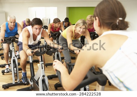 Group Taking Part In Spinning Class In Gym Royalty-Free Stock Photo #284222528