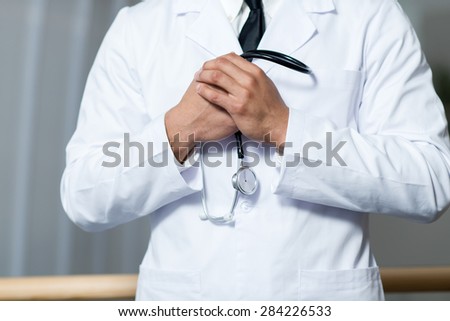 Close up of hands of doctor in a hospital. Stethoscope medical concept.