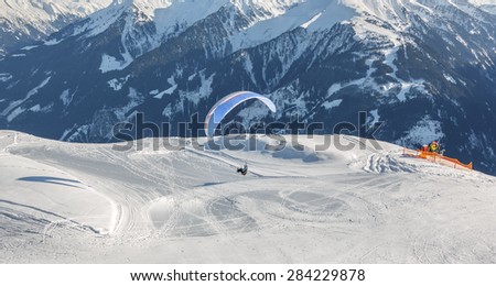 The pilot begins flight on a paraplane with a mountain-skiing slope of Penken - Mayrhofen, Austria 