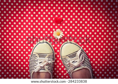A Heart, a daisy and striped pumps on red polka dots