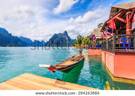  landscape and long-tailed boat  in Ratchaprapha Dam at Khao Sok National Park, Surat Thani Province, Thailand. Royalty-Free Stock Photo #284263886