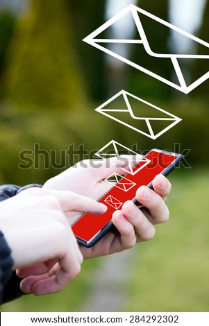 Man is writing email from mobile phone, nature background
