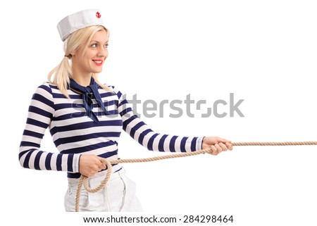 Cheerful female sailor pulling a rope and smiling isolated on white background