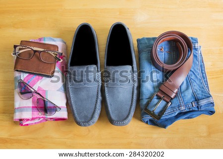 Men's casual outfits on wooden background, vintage style