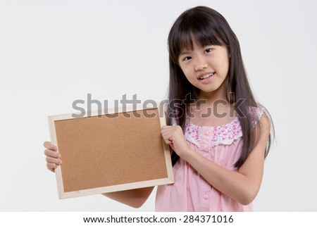 Little Asian child holding empty board on isolated background