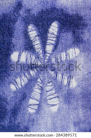 Abstract flower on blue fabric.
