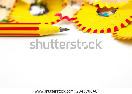 pencil for drawing and shavings on a white background