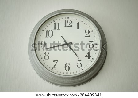 Vintage clock on a white wall vintage style