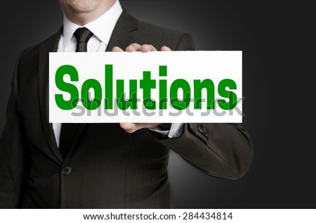 Solutions sign is held by businessman.
