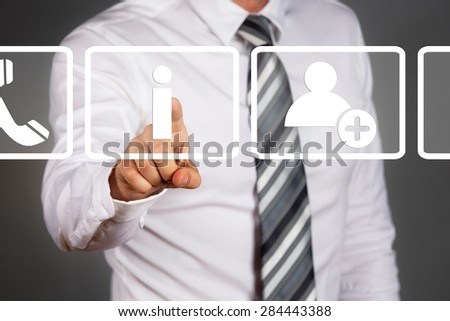 New technology concept. Businessman touching display. White, simple info, contact, headphone icons.
