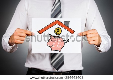 Money insurance.  Pink piggy bank under home roof drawing.
